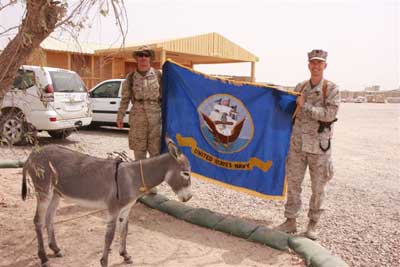 NAVY men stop by to have their photo made with the donkey